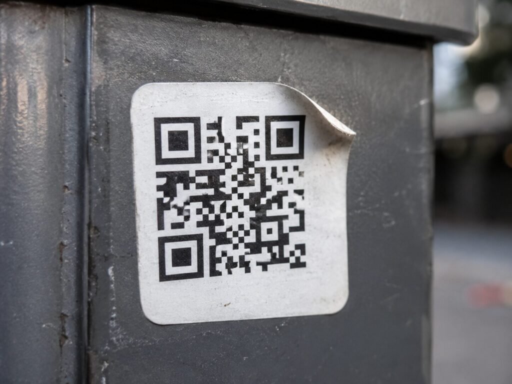 Tampered QR code sticker, a common sign of a quishing scam