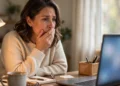 Worried woman looking at a laptop screen at home after clicking a suspicious link