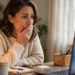 Worried woman looking at a laptop screen at home after clicking a suspicious link