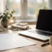 A clean one-page resume printed on paper beside a laptop on a bright desk, with a coffee cup nearby